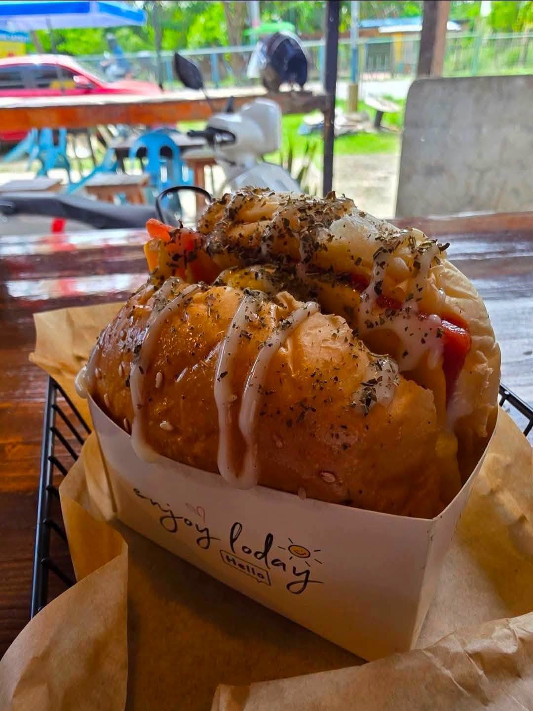 Loaded egg sandwich with signature sauce and herbs